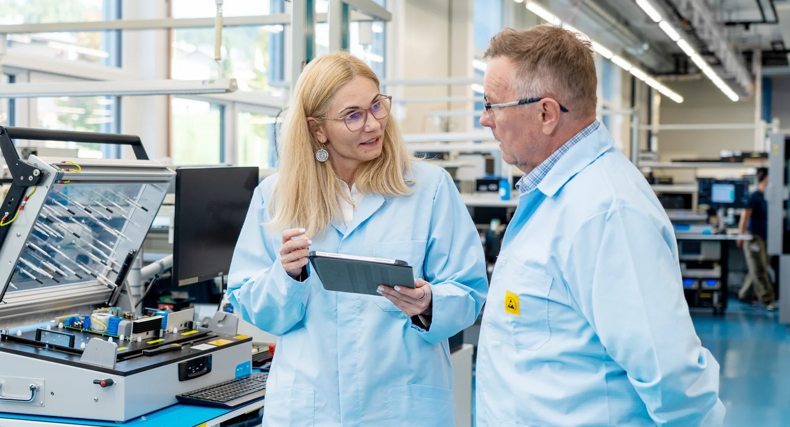 Andreea Matei and Dan Negrea from Cicor discussing medical device development in a production environment.
