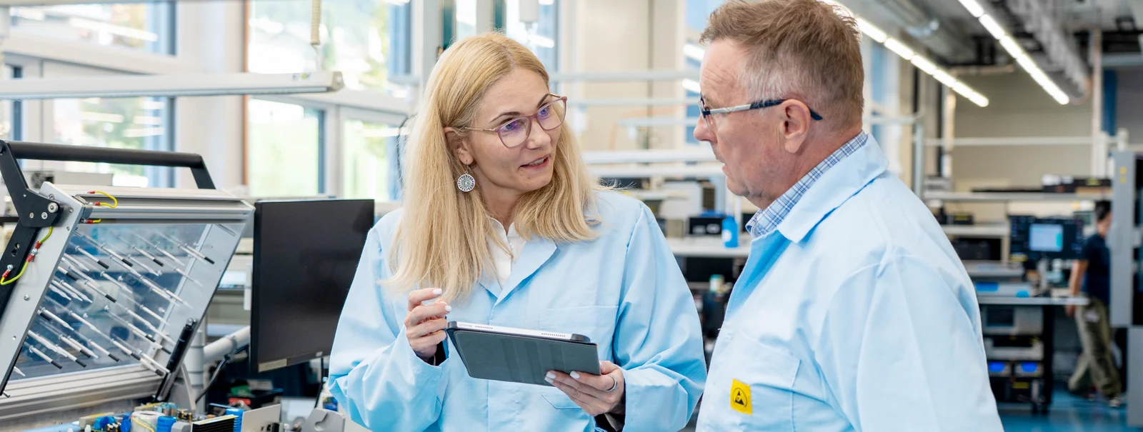 Andreea Matei and Dan Negrea from Cicor discussing medical device development in a production environment.