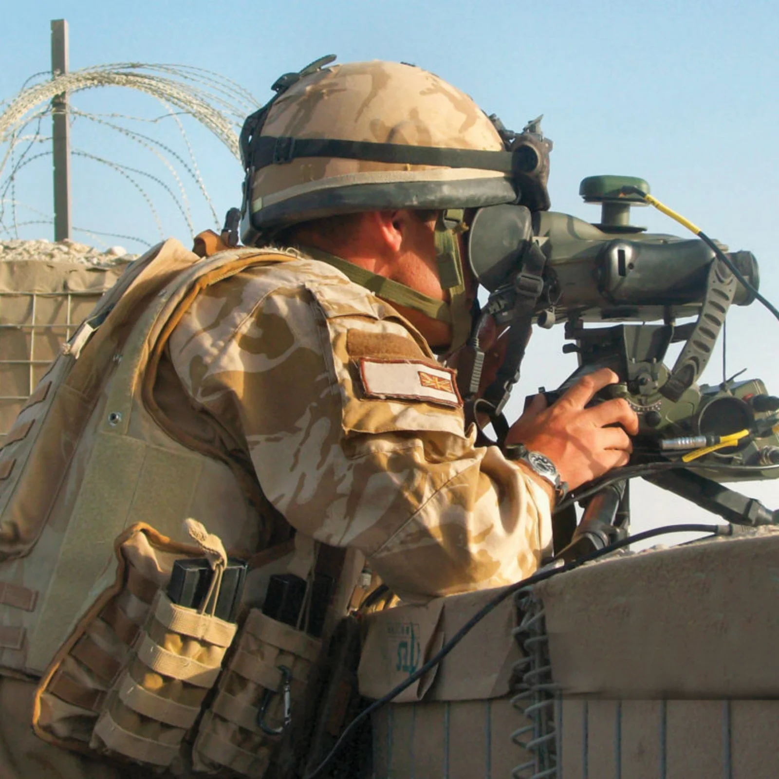 Soldier operating targeting equipment, illustrating Cicor land defence electronics.