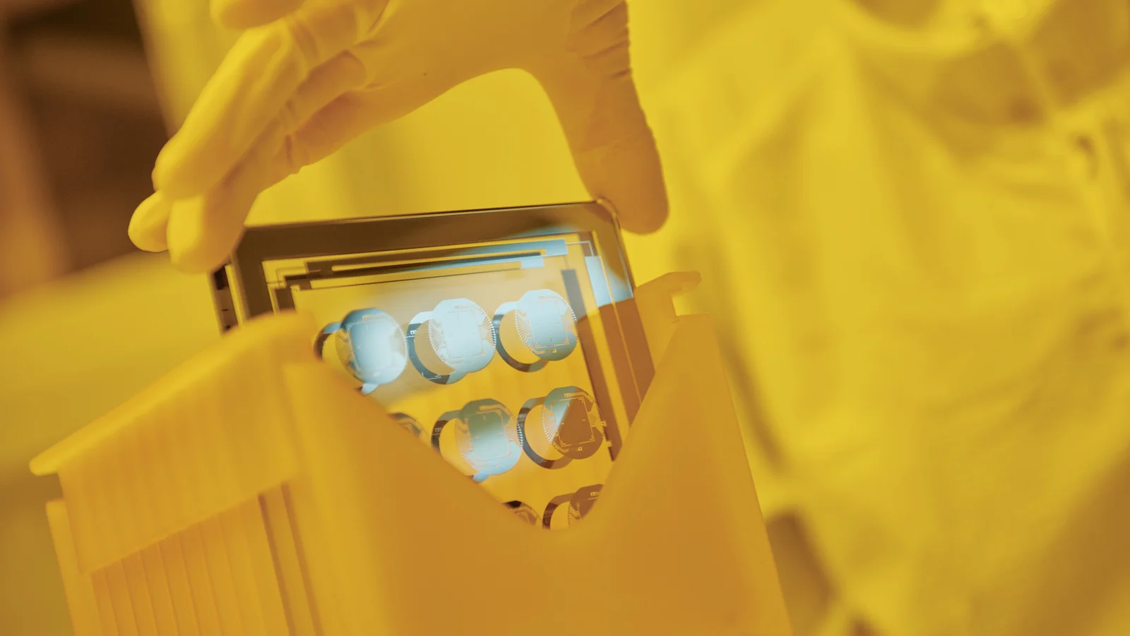 Cicor employee holding a thin-film substate at the production site in Wangs, Switzerland