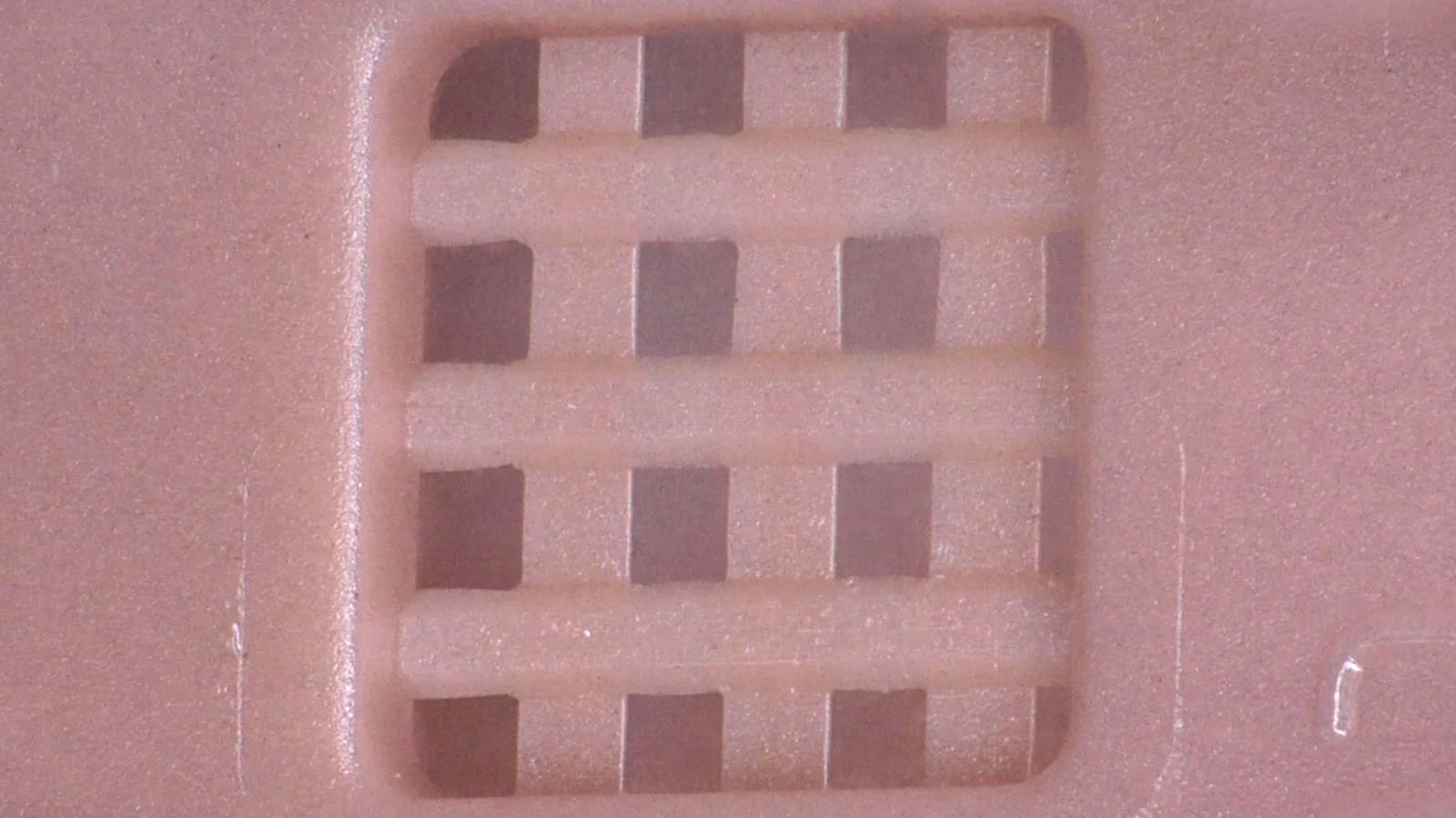 Close-up of a micro-molded plastic part demonstrating Cicor's precision plastics capabilities.