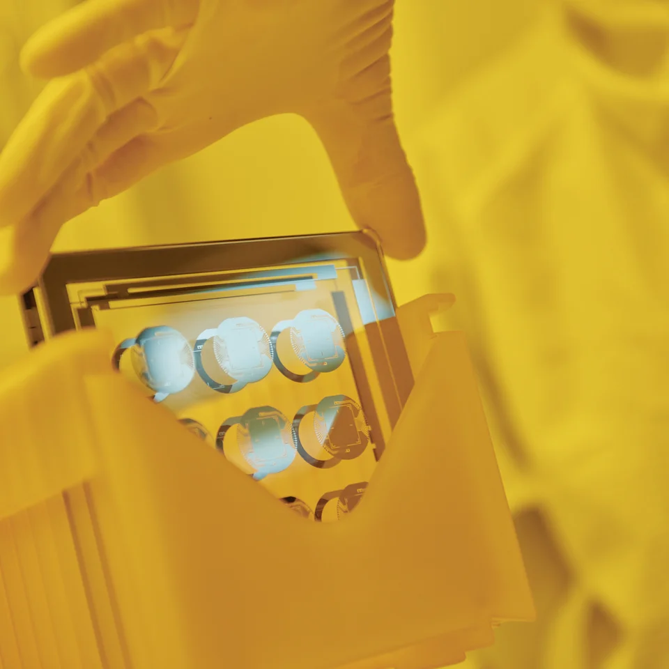 Cicor employee holding a thin-film substate at the production site in Wangs, Switzerland