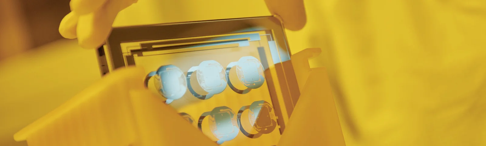 Cicor employee holding a thin-film substate at the production site in Wangs, Switzerland